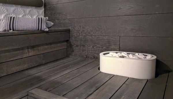 White Tulikivi Halla integrated into dark waxed sauna benches, close-up