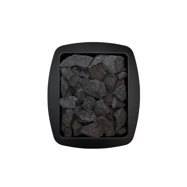 Narvi NC Wood Burning Sauna Heater filled with grey sauna stones on a white background