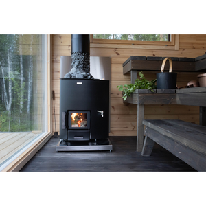 Narvi Wood-burning stove in a wooden cabin with a view of trees outside.