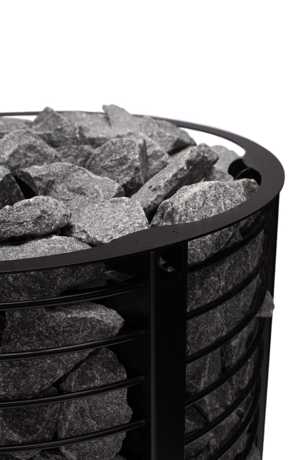 Narvi Inari Wood Burning Sauna Heater filled with grey sauna stones on a white background  