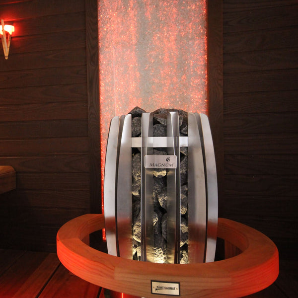 Infrared sauna with wooden benches and a red light on the wall.