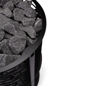 Narvi Inari Plus Wood Burning Sauna Heater filled with grey sauna stones on a white background