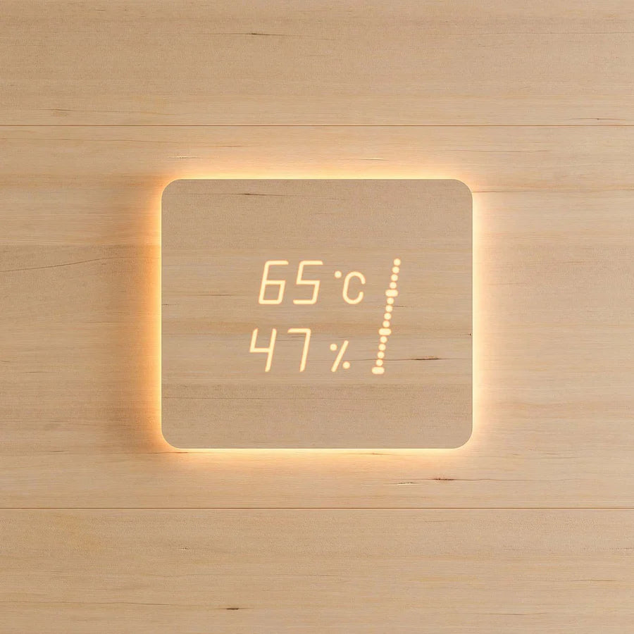 Digital thermometer and humidity gauge on a wooden wall