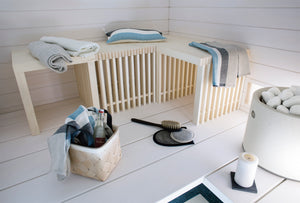 Round Standing Cast Stone Cladded Electric Sauna Heater Tulikivi Kuura 1 Integrated Into White Sauna, Further Away