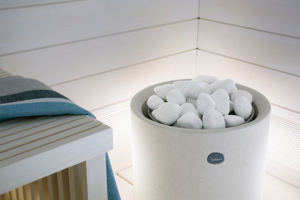 Round Standing Cast Stone Cladded Electric Sauna Heater Tulikivi Kuura 1 Integrated Into White Sauna, Close