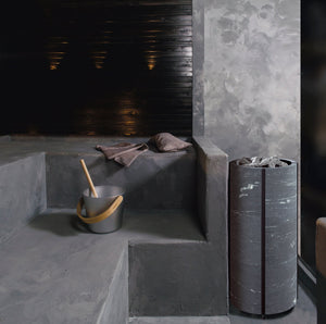 Round Standing Soapstone Cladded Electric Sauna Heater Tulikivi Naava Nobile In Concrete Sauna