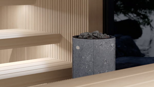 Tulikivi Kaarna L Nobile Electric Sauna Heater with grey sauna stones in a wooden sauna