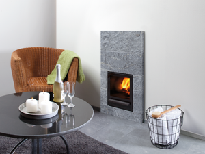 Tulikivi Kinos TBH Wood Burning Sauna Heater in a room with interior furniture 