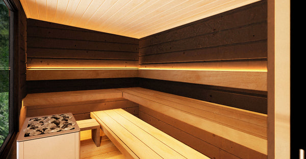 Wooden sauna with bench and stove, illuminated by warm lights.