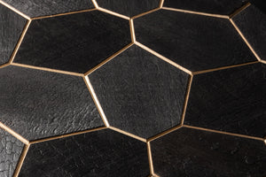 Close-up of black hexagonal tiles with gold edges