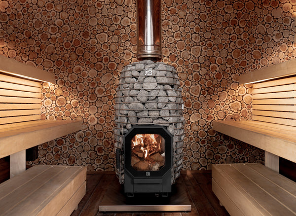 HUUM wood burning sauna heater with grey stones in a wooden sauna