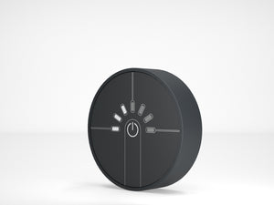 Round black control panel with power symbol on a white background
