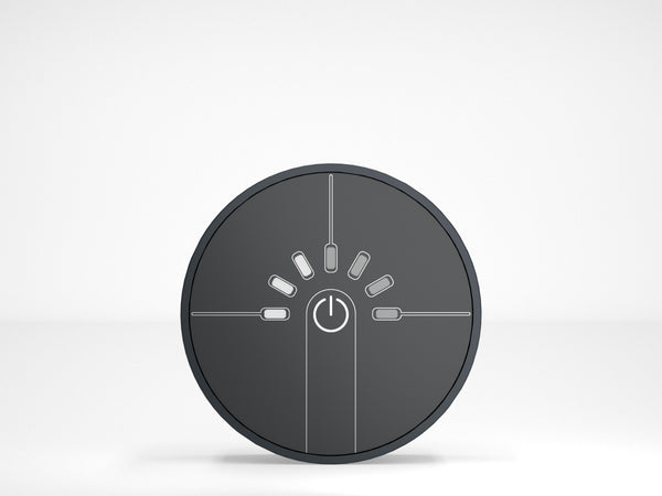 Round black control panel with power symbol on a white background