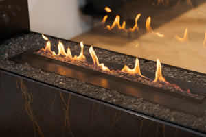 Close-up of a gas fireplace with flames and reflective surface