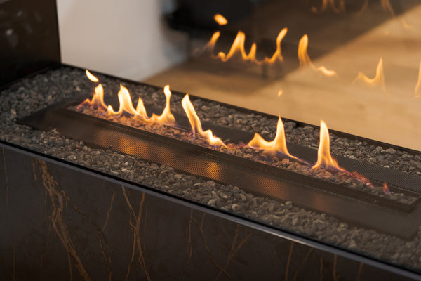 Close-up of a gas fireplace with flames and reflective surface