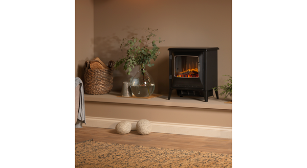 Dimplex Lucia FSC freestanding electric stove placed in a living room interior, creating warm ambient lighting.