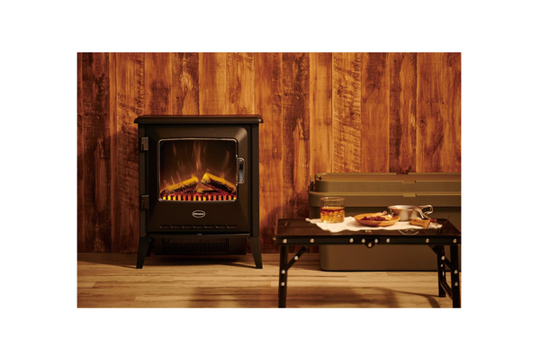 Dimplex Lucia FSC electric stove displayed in a rustic interior with wooden wall background and glowing flame effect.