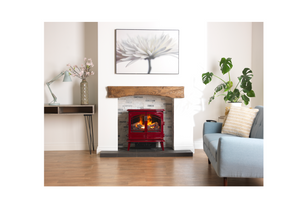 Red freestanding electric stove installed in a traditional fireplace opening within a modern living room interior.