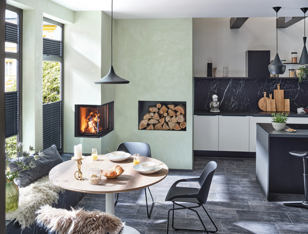 Modern kitchen and dining area with a fireplace and open-plan layout.