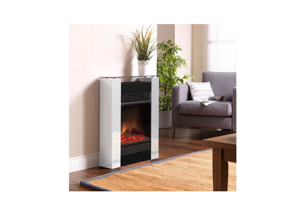 Electric fireplace in a living room setting with a gray sofa and plants.