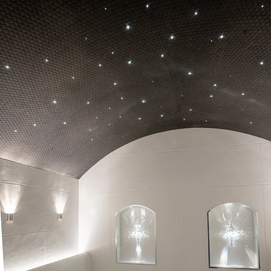 Ceiling with starlight effect and wall lights in a modern interior setting