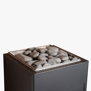 Electric sauna heater with stones on top against a white background