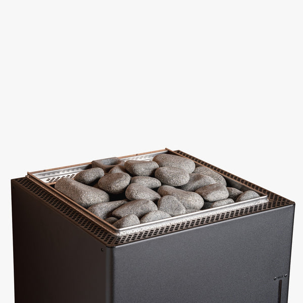 Electric sauna heater with stones on top against a white background
