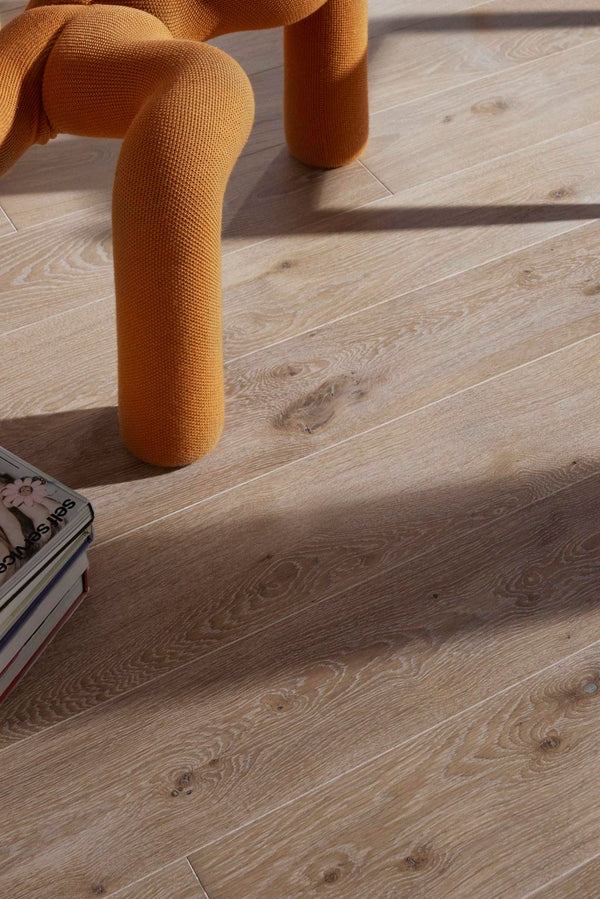 Wooden floor with a textured chair leg and book in the foreground