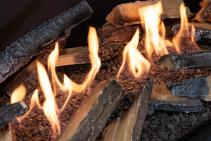 Close-up of burning logs with flames in a fireplace
