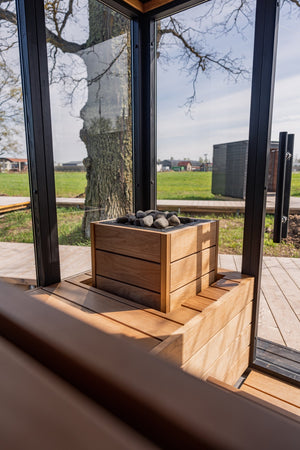 HUUM Core Bk electric sauna heater with stones  in a wooden sauna  