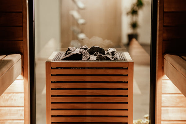 HUUM Core Bk electric sauna heater with stones  in a wooden sauna  