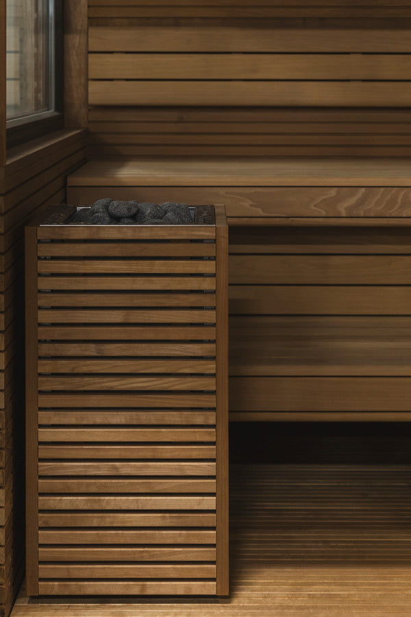 HUUM Core Bk electric sauna heater with stones  in a wooden sauna  