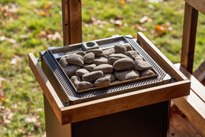 Electric sauna heater with stones on a grassy outdoor setting
