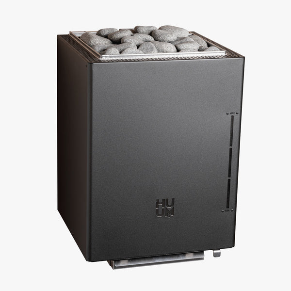 Black sauna heater with rocks on top on a white background