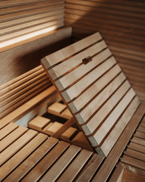 Wooden bench with slatted design in a warm-toned setting