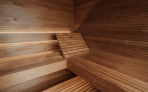 Wooden sauna interior with benches and walls.