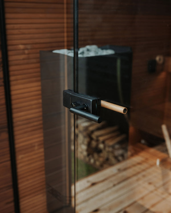 Glass door with black handle and wooden interior