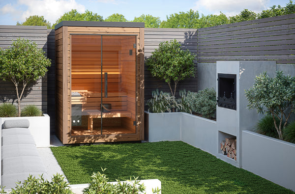 Outdoor sauna with wooden exterior and glass door in a garden setting.