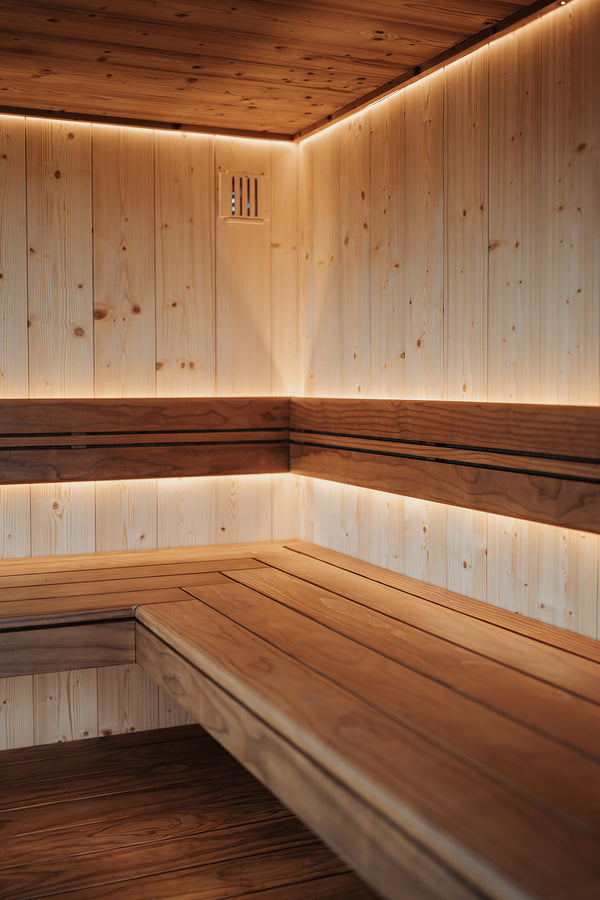 Wooden sauna interior with benches and LED lighting