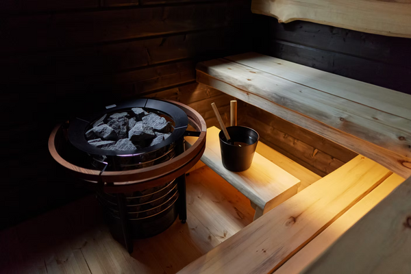 Wooden sauna interior with a stove and bench