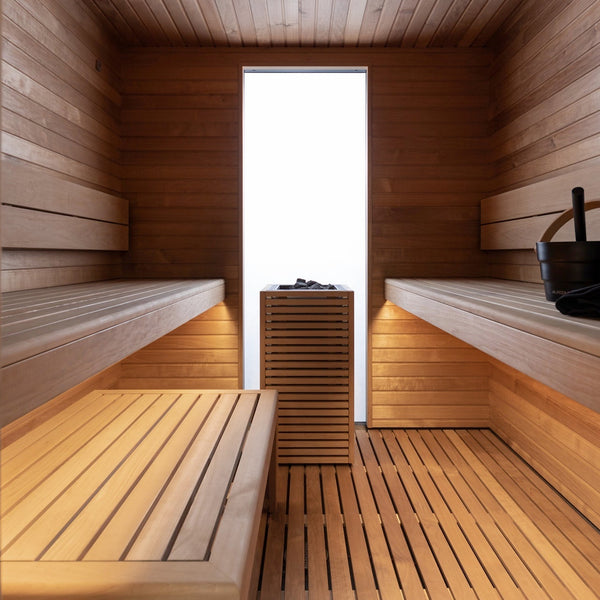 Wooden sauna interior with benches and a central cabinet.