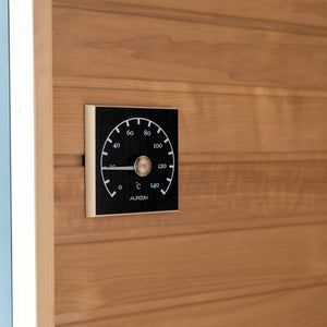 Wooden sauna door with a temperature control panel displaying 'AUROROOM'.