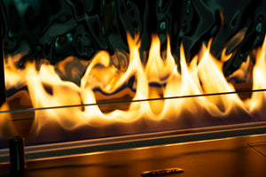 Close-up of flames in a fireplace with glass barrier