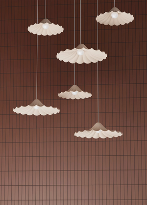 Set of five pendant lights with scalloped edges on a brown grid background