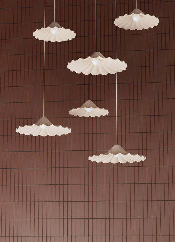 Set of five pendant lights with scalloped edges on a brown grid background