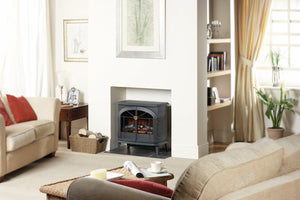 Living room with a fireplace, sofa, and decorative items.