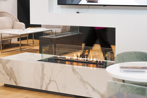 Modern living room with a marble fireplace and television above