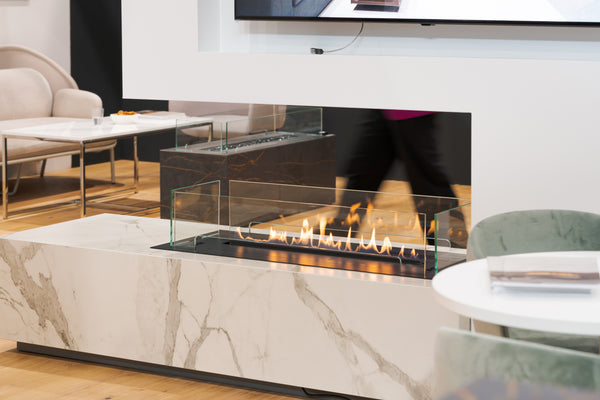 Modern living room with a marble fireplace and television above