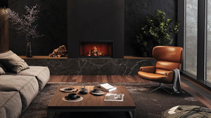 Modern living room with a fireplace, brown leather chair, and gray sofa.