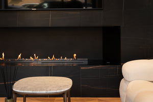 a close up picture of fireplace and part of a white couch and coffee table